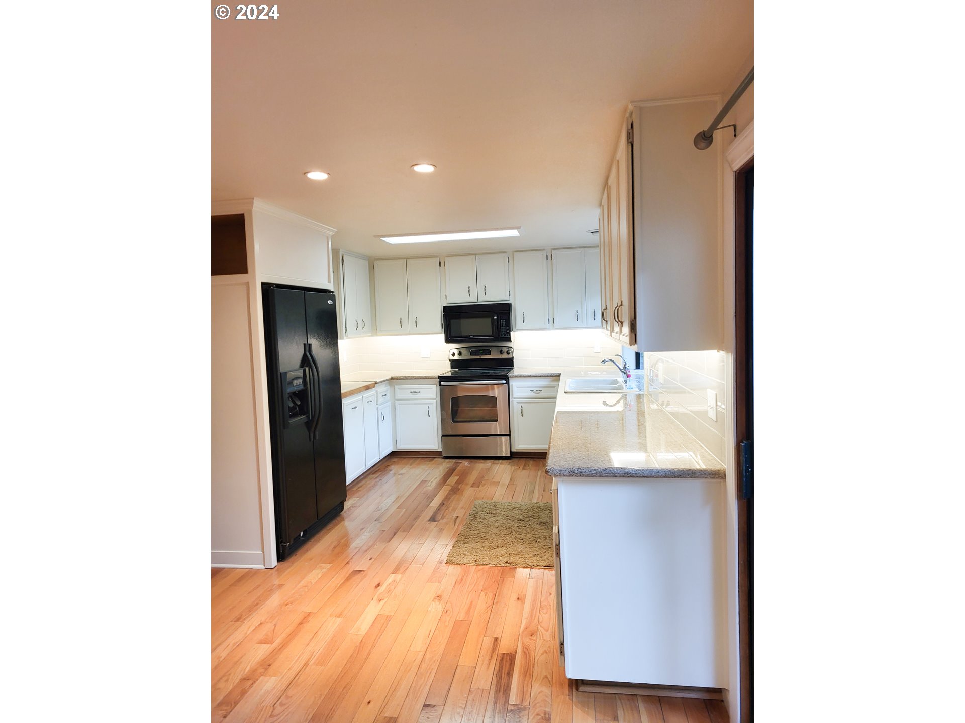 3431 Timberline Drive Eugene, OR 97405 - Photo 21 of 39 a kitchen with granite countertop a refrigerator oven a sink and dishwasher