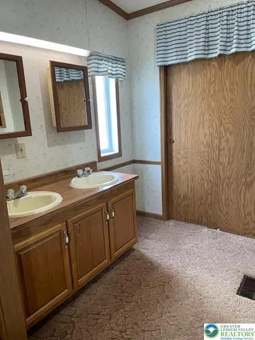 a bathroom with a double vanity sink and mirror