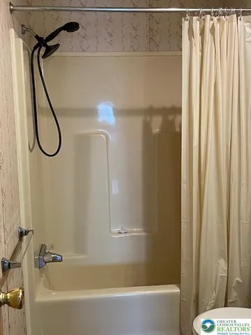 a bathroom with a shower and a bath tub