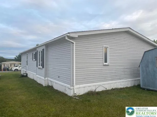 a view of a house with a backyard
