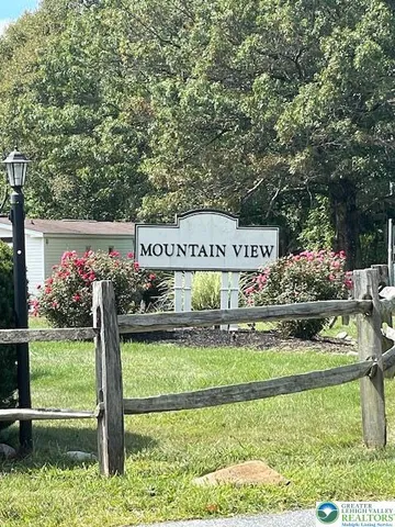 a view of a sign board with garden
