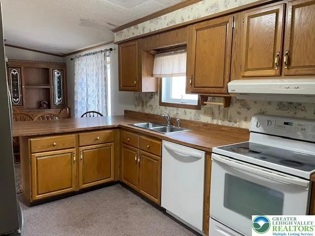 a kitchen with granite countertop cabinets stainless steel appliances a sink and window