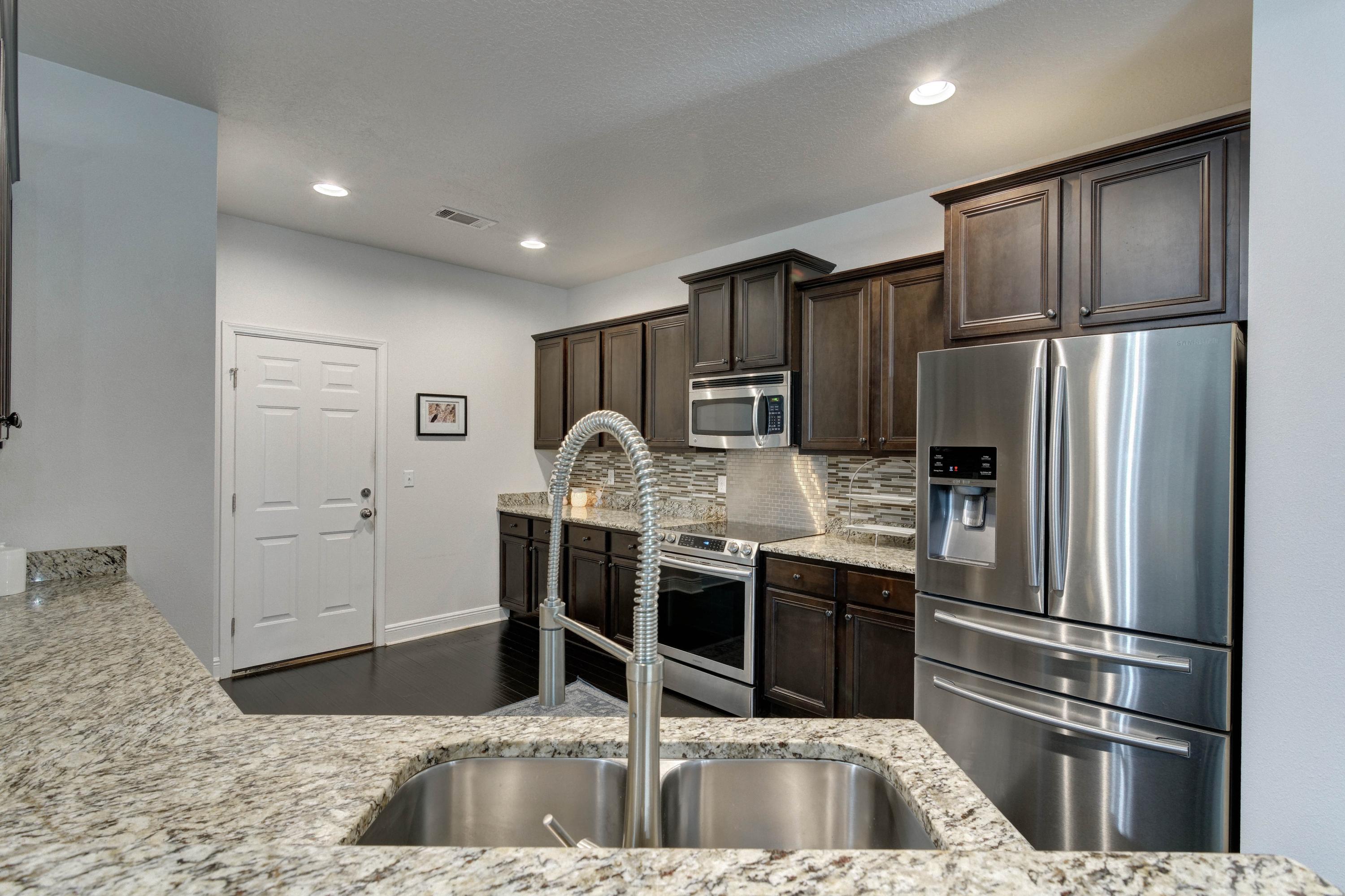 52 Mango Lane Freeport, FL 32439 - Photo 18 of 69 a kitchen with stainless steel appliances granite countertop a refrigerator and a sink
