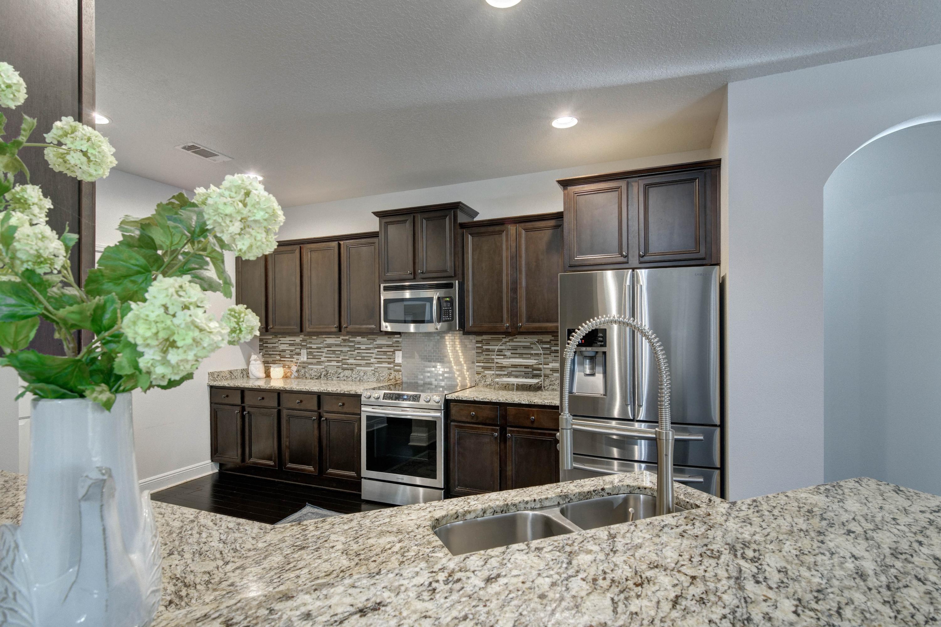 52 Mango Lane Freeport, FL 32439 - Photo 19 of 69 a kitchen with stainless steel appliances kitchen island granite countertop a refrigerator and a sink