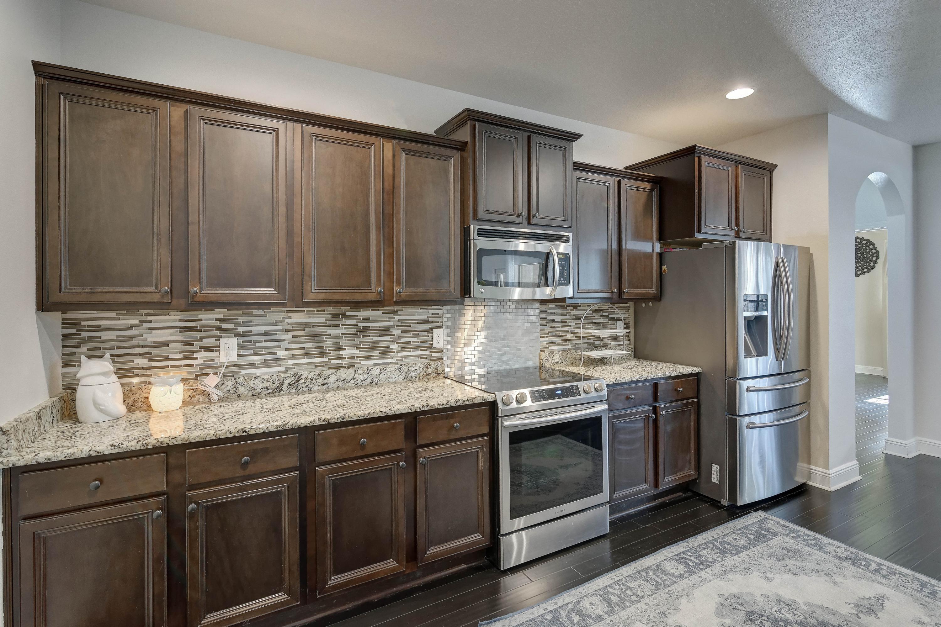 52 Mango Lane Freeport, FL 32439 - Photo 21 of 69 a kitchen with stainless steel appliances granite countertop a refrigerator a stove a sink and dishwasher