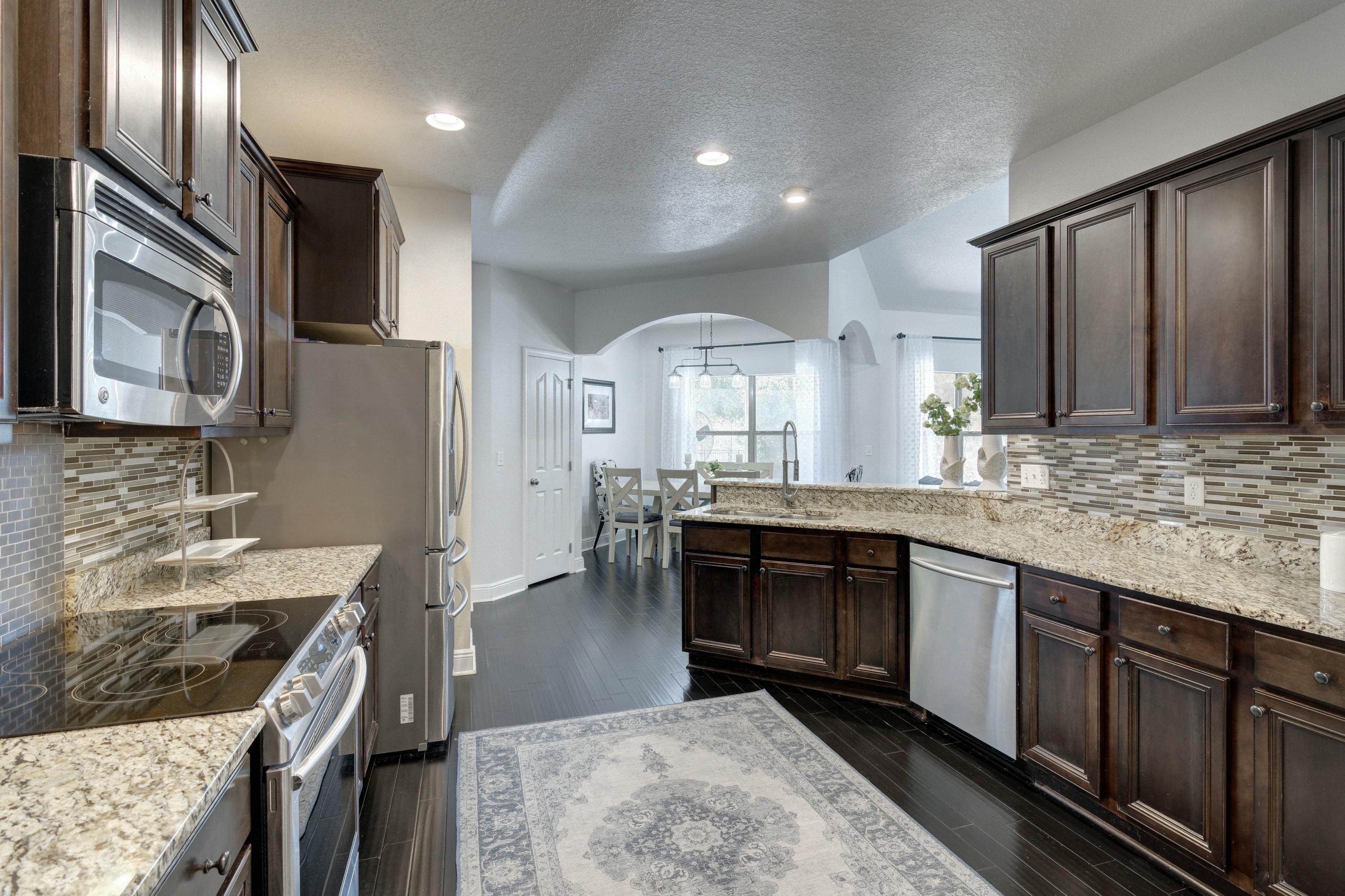 52 Mango Lane Freeport, FL 32439 - Photo 22 of 69 a kitchen with stainless steel appliances granite countertop a sink stove and refrigerator