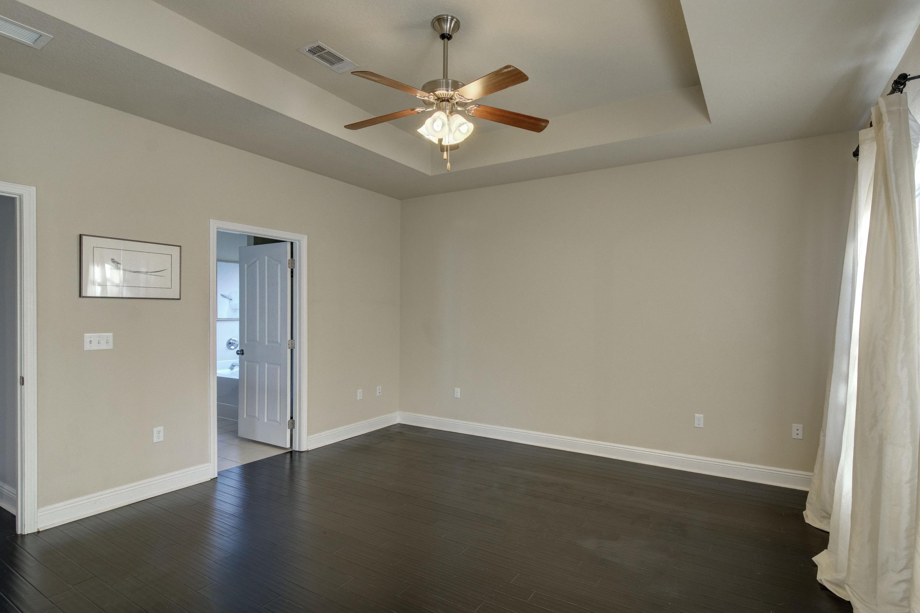 52 Mango Lane Freeport, FL 32439 - Photo 25 of 69 an empty room with wooden floor and a ceiling fan