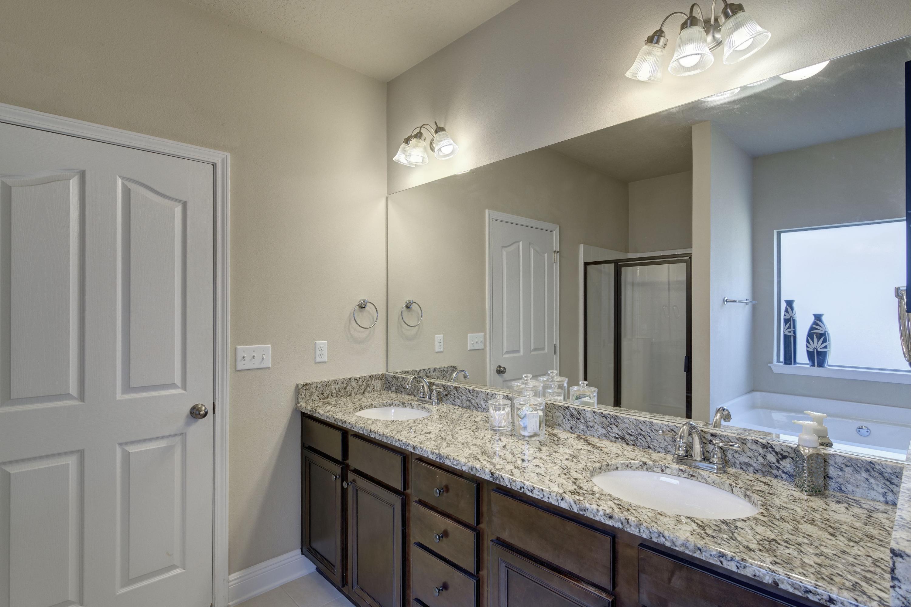 52 Mango Lane Freeport, FL 32439 - Photo 30 of 69 a bathroom with a granite countertop double vanity sink and a mirror