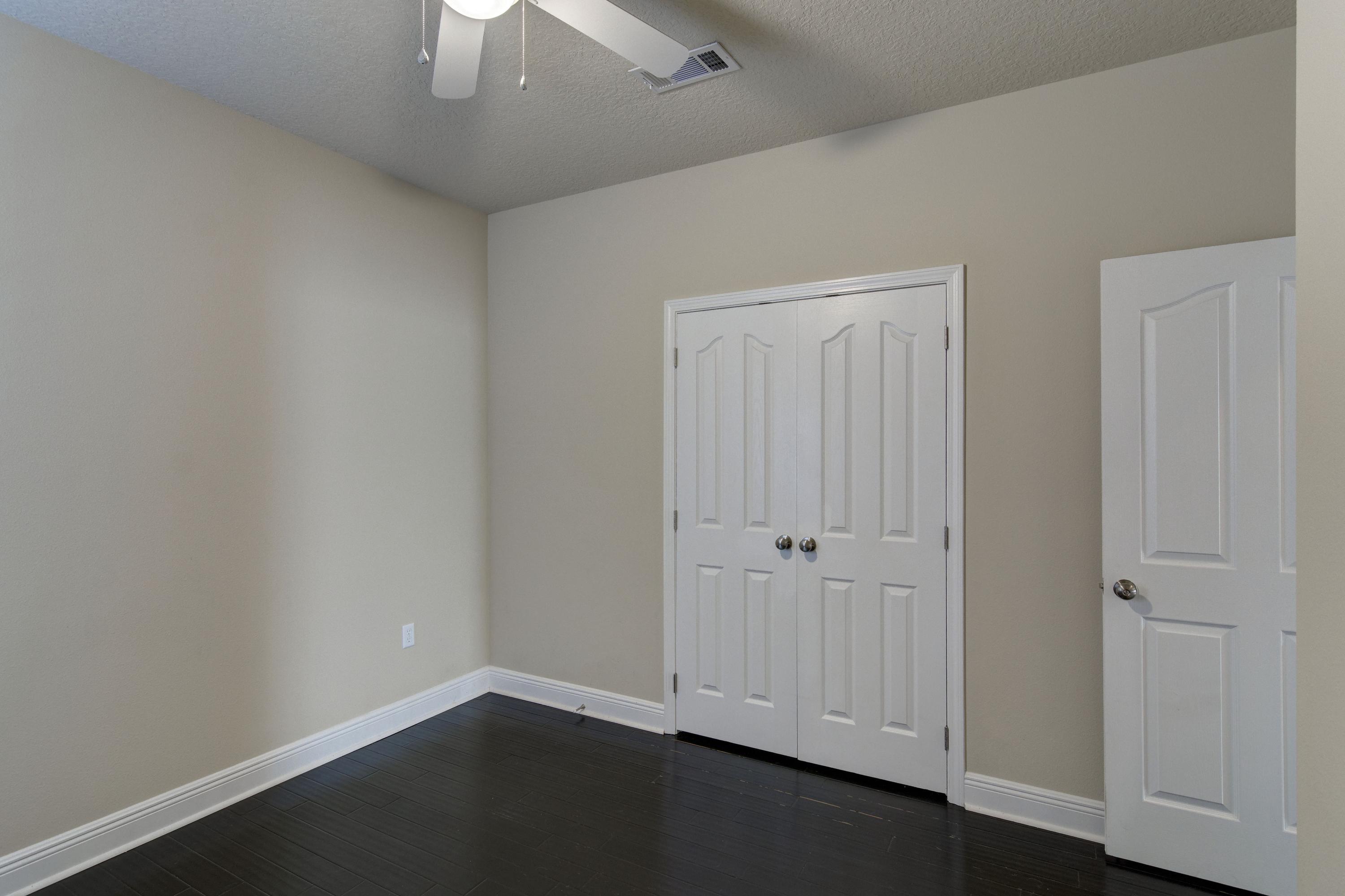 52 Mango Lane Freeport, FL 32439 - Photo 34 of 69 an empty room with a ceiling fan and carpet