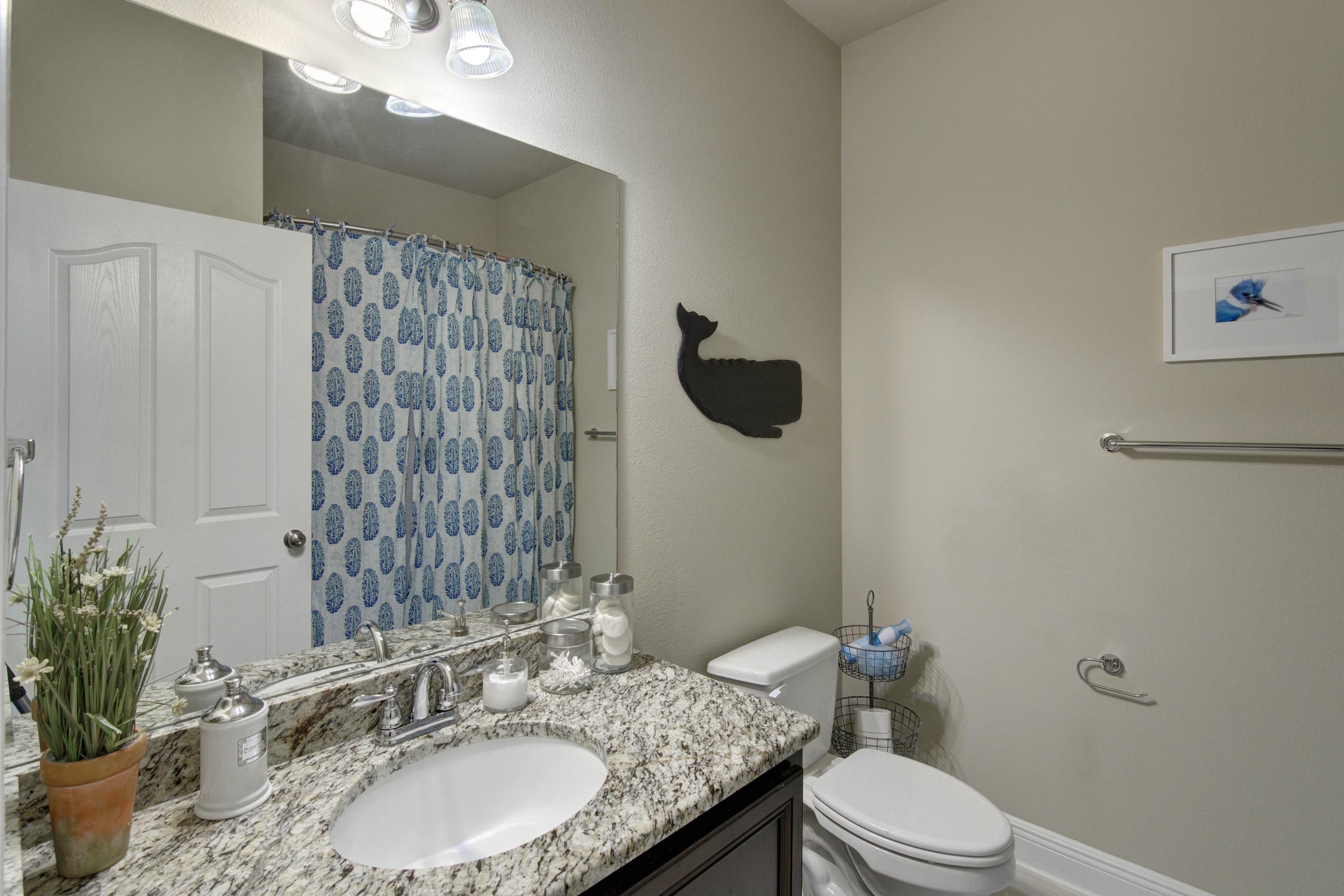 52 Mango Lane Freeport, FL 32439 - Photo 36 of 69 a bathroom with a granite countertop sink a toilet and a mirror