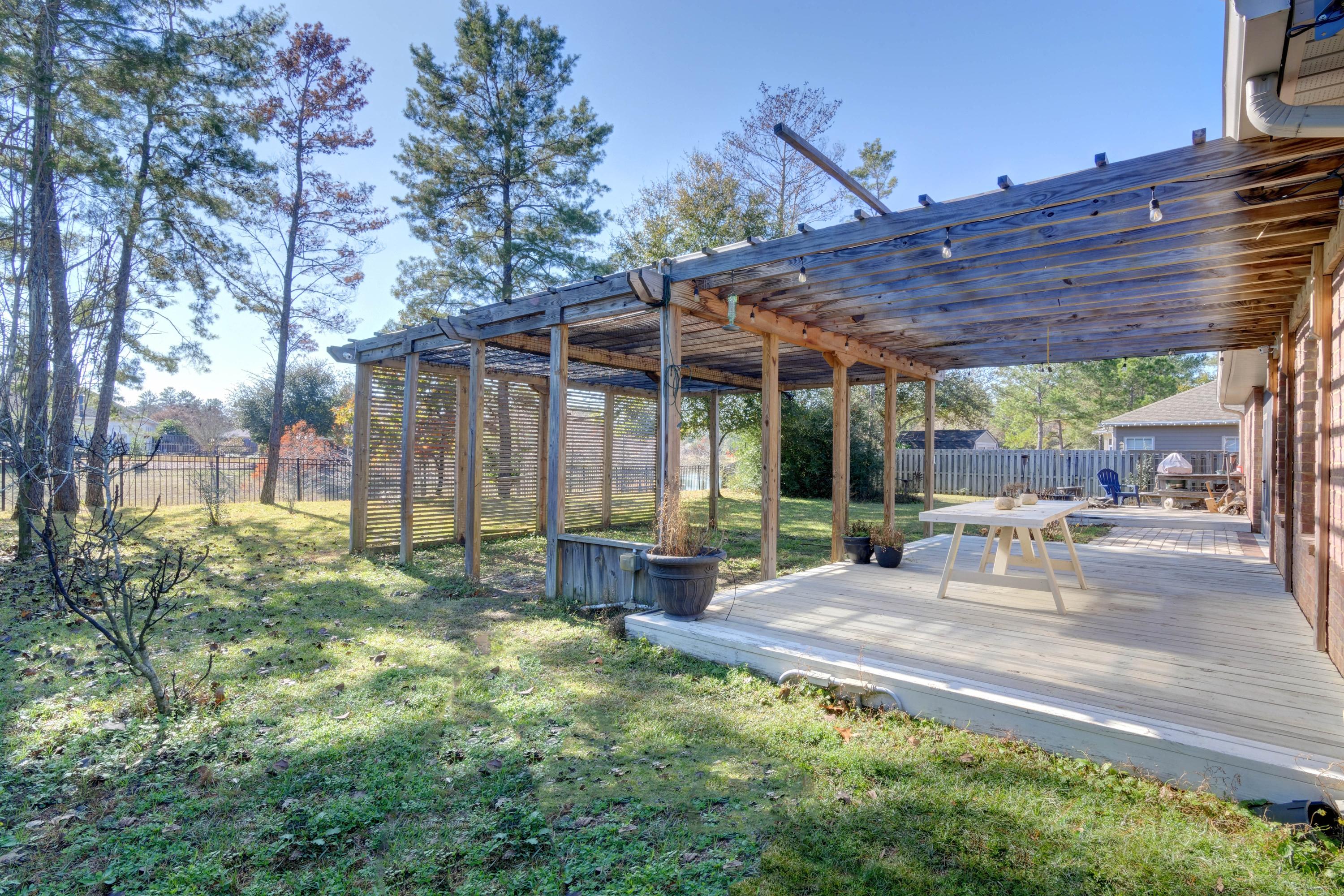 52 Mango Lane Freeport, FL 32439 - Photo 46 of 69 a view of a backyard with table and chairs under an umbrella with a big yard