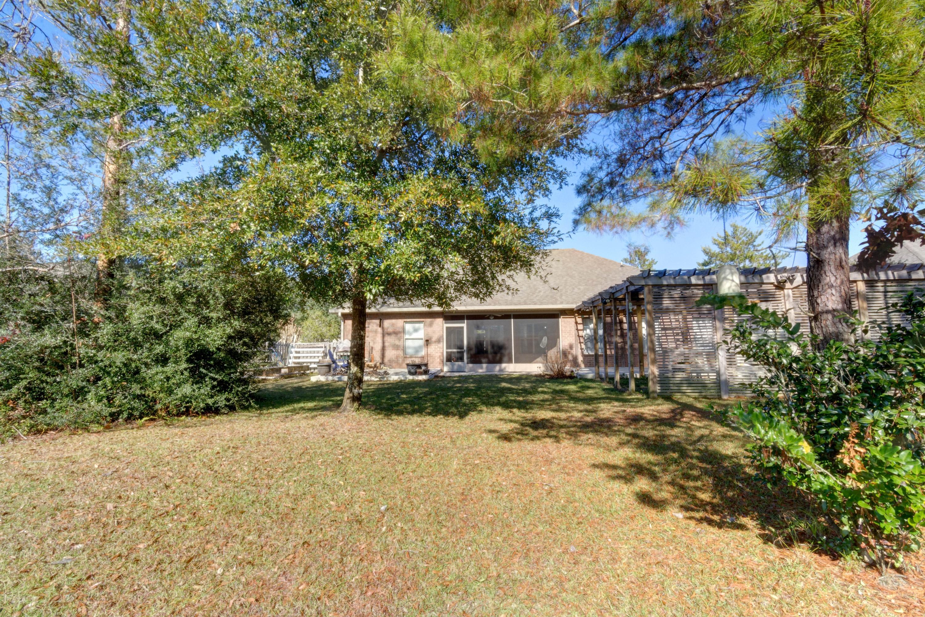 52 Mango Lane Freeport, FL 32439 - Photo 50 of 69 a view of a house with a tree in the background