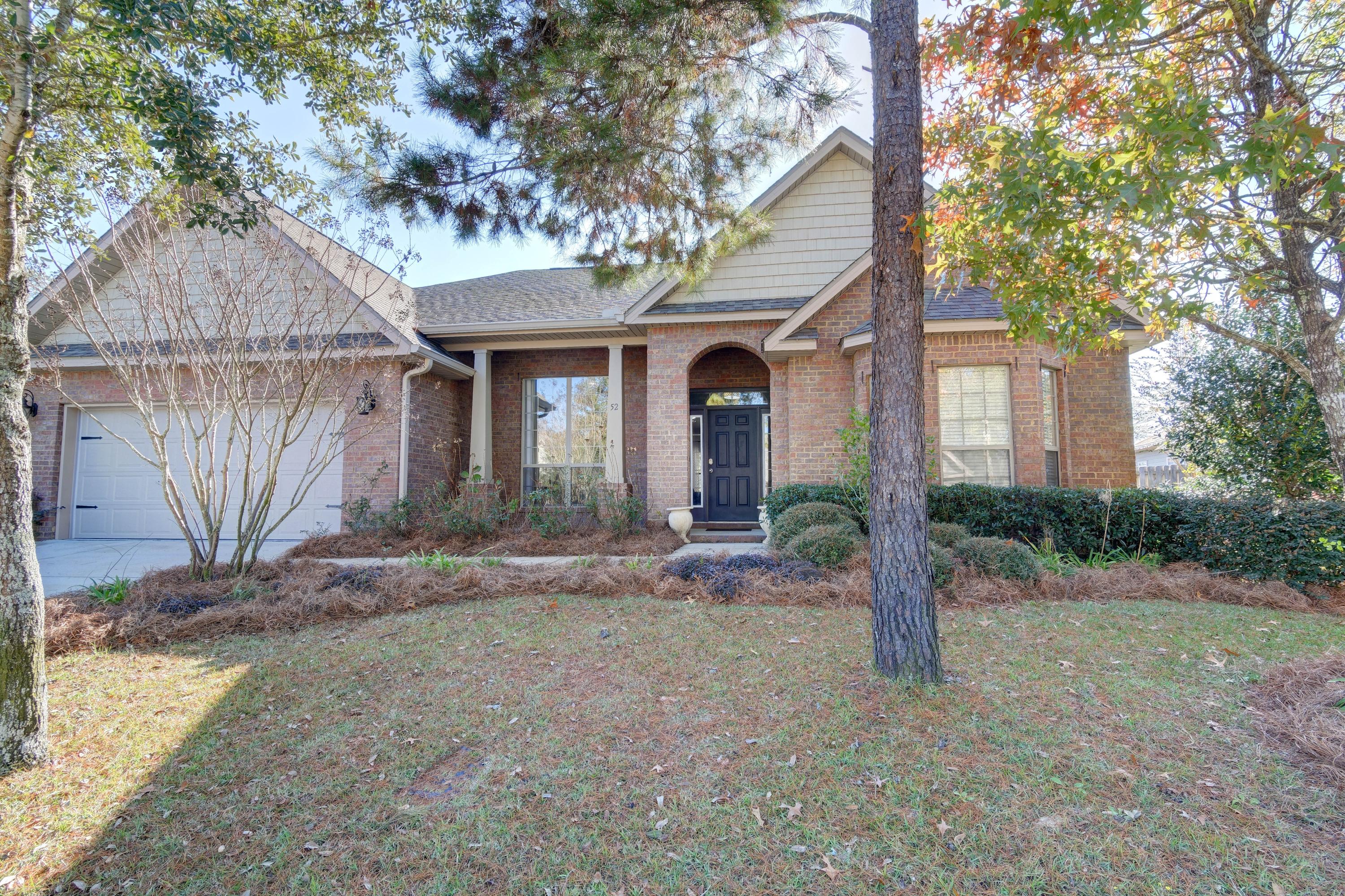 52 Mango Lane Freeport, FL 32439 - Photo 55 of 69 a view of a yard in front of a house with large tree