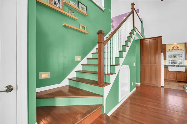 a view of a dining room with furniture a chandelier and wooden floor