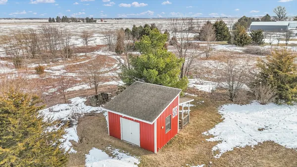 a view of a house with snow on the road