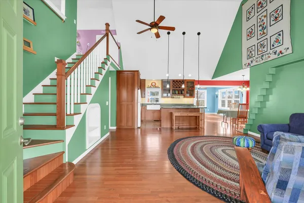 a living room with furniture or wooden floor and a ceiling fan