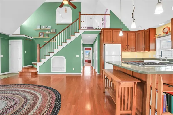 a kitchen with stainless steel appliances granite countertop a stove top oven a sink and a refrigerator