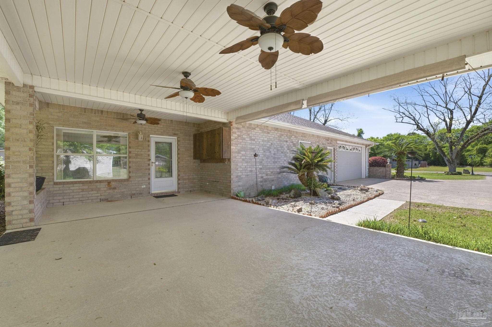 4552 Peaden Road Pace, FL 32571 - Photo 38 of 38 a view of a porch with a table and chairs