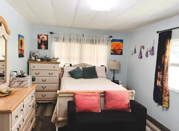 a bedroom with a bed and a flat tv screen