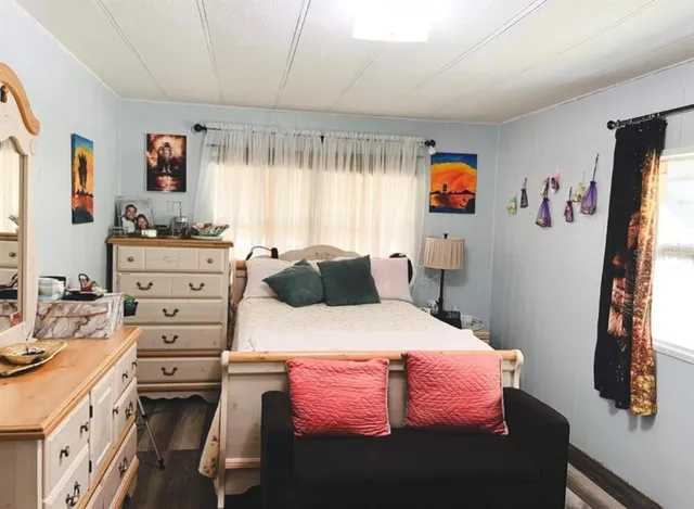 a bedroom with a bed and a flat tv screen