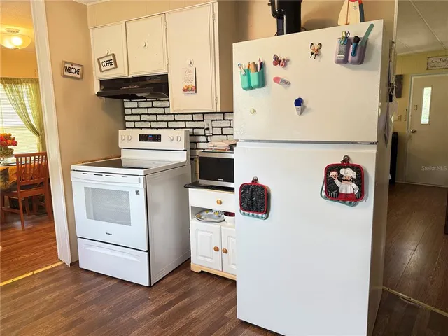 a white refrigerator freezer sitting inside of a kitchen