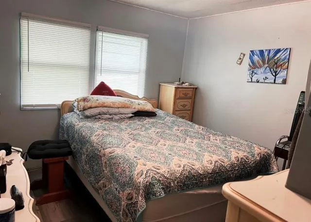 a bedroom with a bed and a window