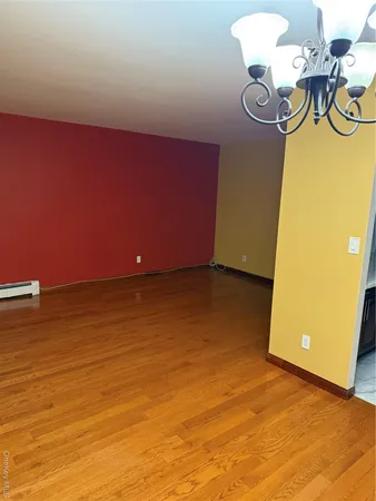 a view of a room with wooden floor