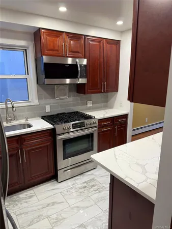 a kitchen with a sink and a stove top oven