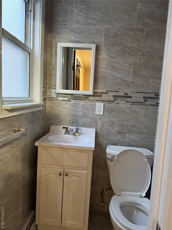a bathroom with a toilet a sink and a mirror