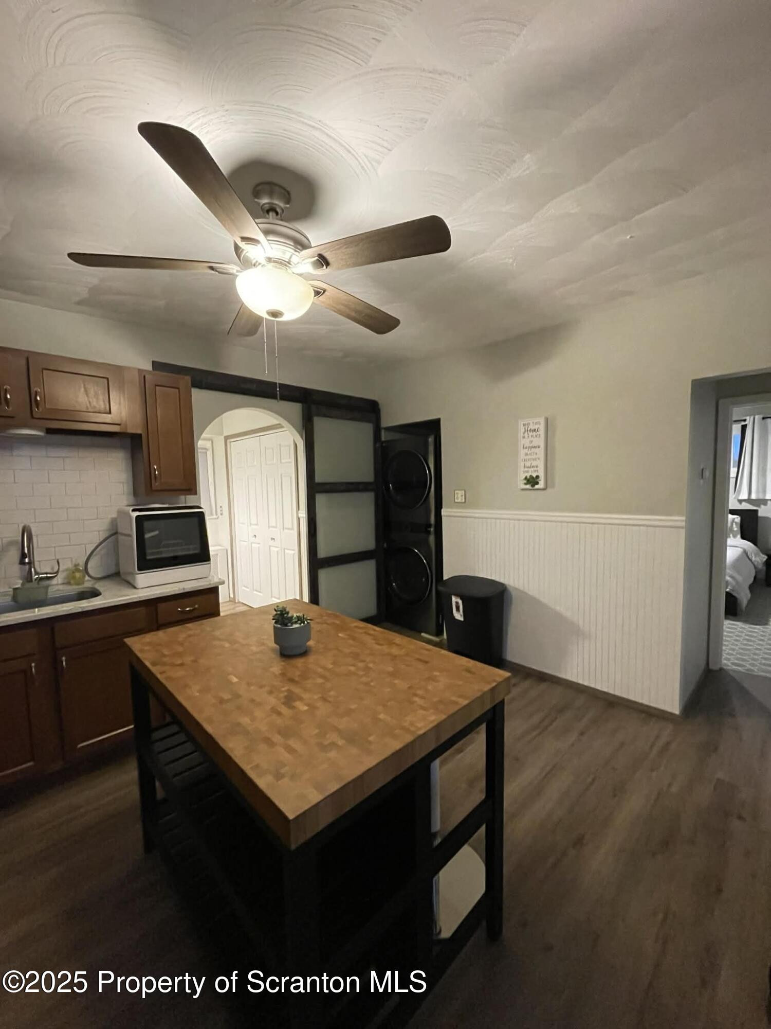 202 Barber Street, Unit 1 Old Forge, PA 18518 - Photo 4 of 9 a view of kitchen island with wooden floor