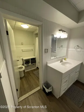 a bathroom with a sink a toilet and a mirror