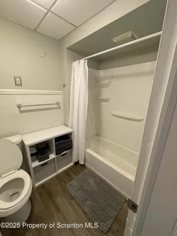 a bathroom with a toilet and a shower