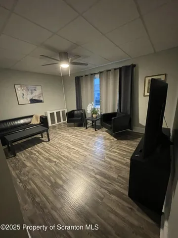 a view of kitchen with furniture and wooden floor