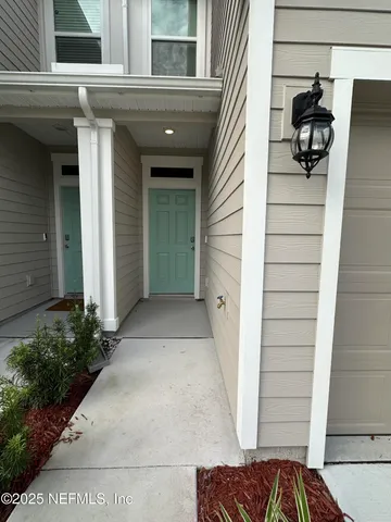 a view of a house with a door and wooden floor