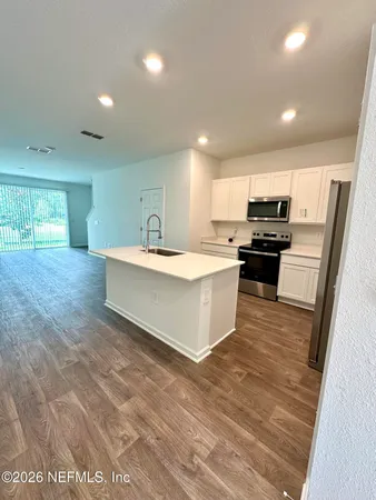 a view of a room with wooden floor and window