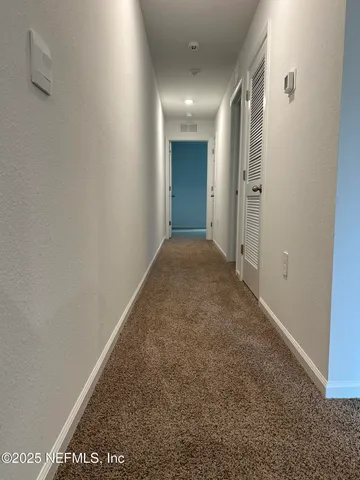 a view of a bathroom with sink and mirror