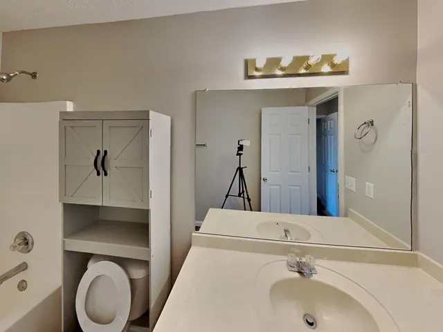 a bathroom with a sink and a mirror
