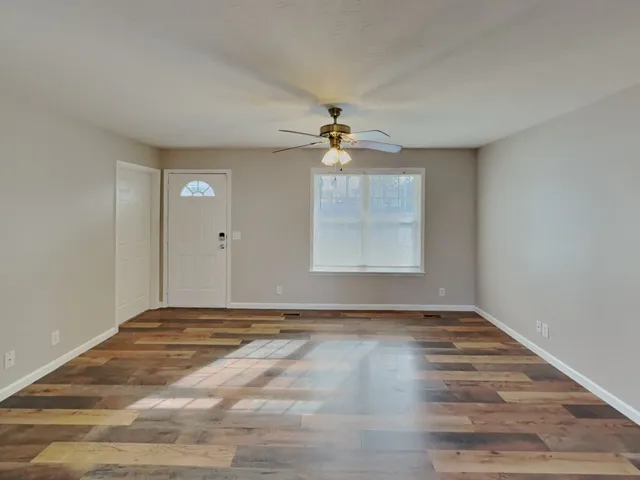 wooden floor in an empty room with a window