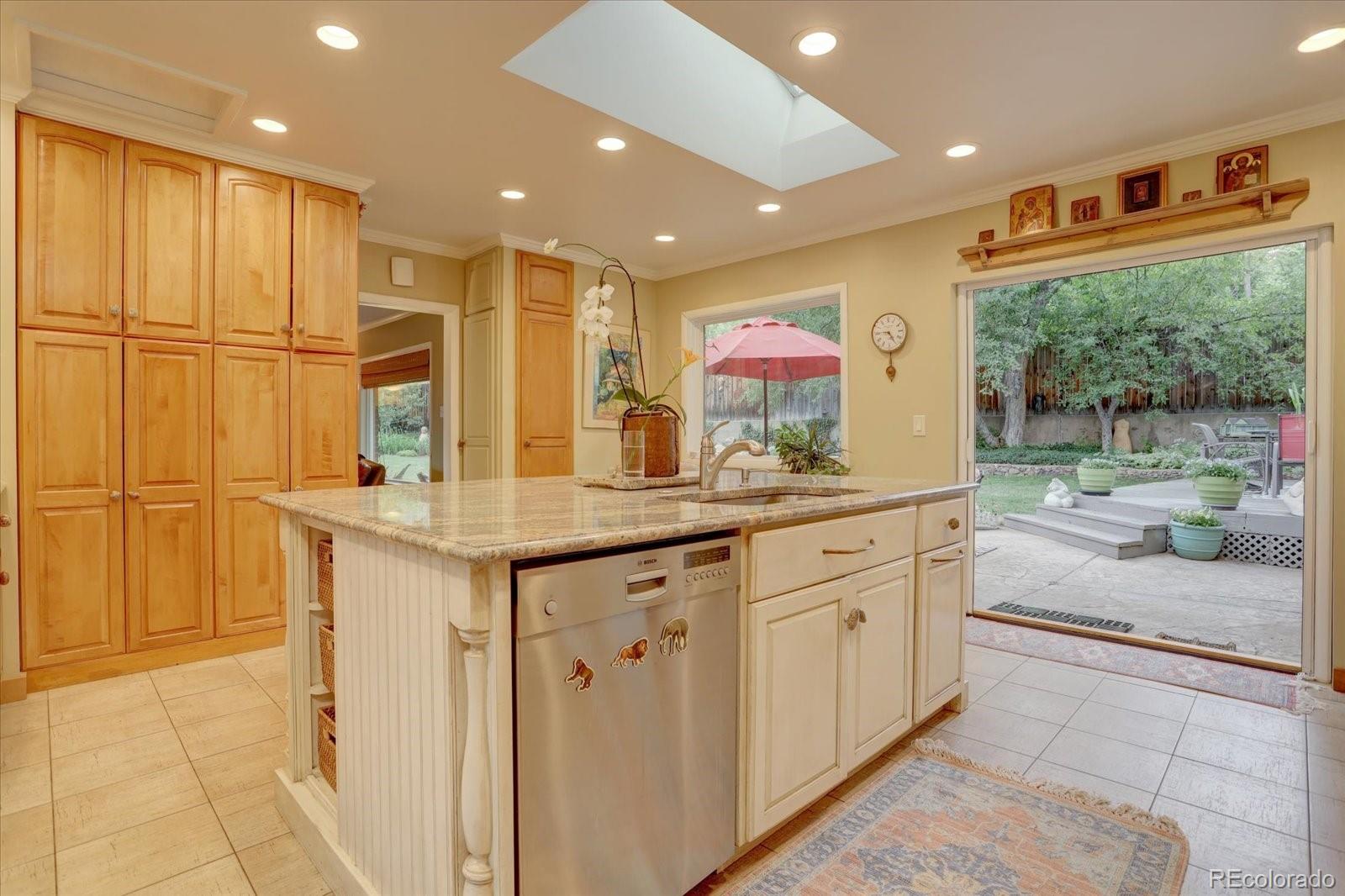 a spacious kitchen with stainless steel appliances granite countertop a sink and cabinets
