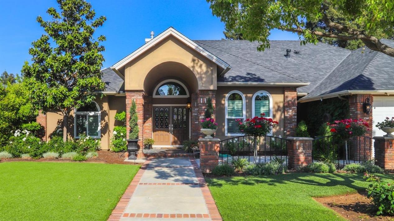 7322 North Geraldine Avenue Fresno, CA 93711 - Photo 1 of 36 a front view of a house with garden