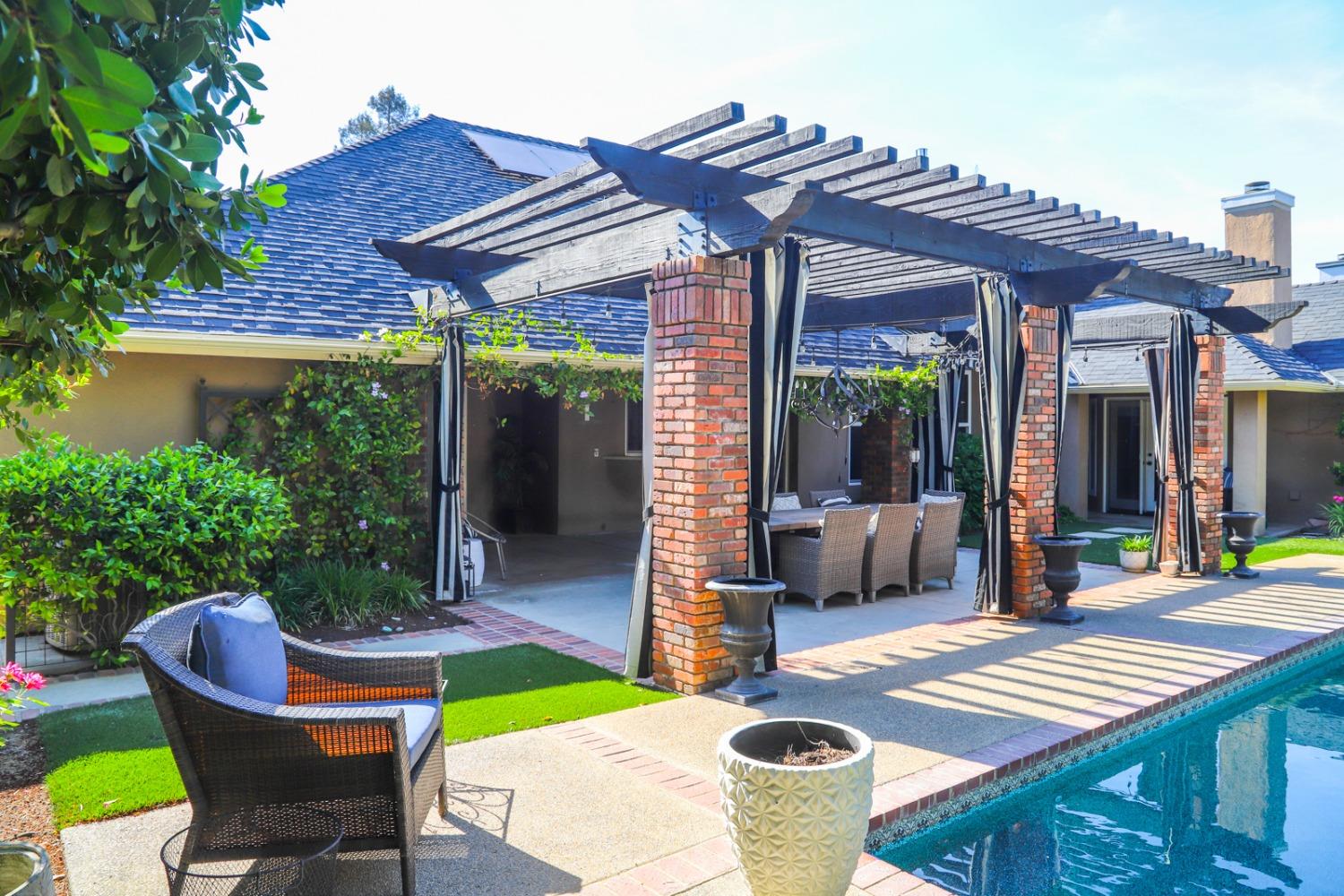 7322 North Geraldine Avenue Fresno, CA 93711 - Photo 13 of 36 a patio with a table and chairs and potted plants