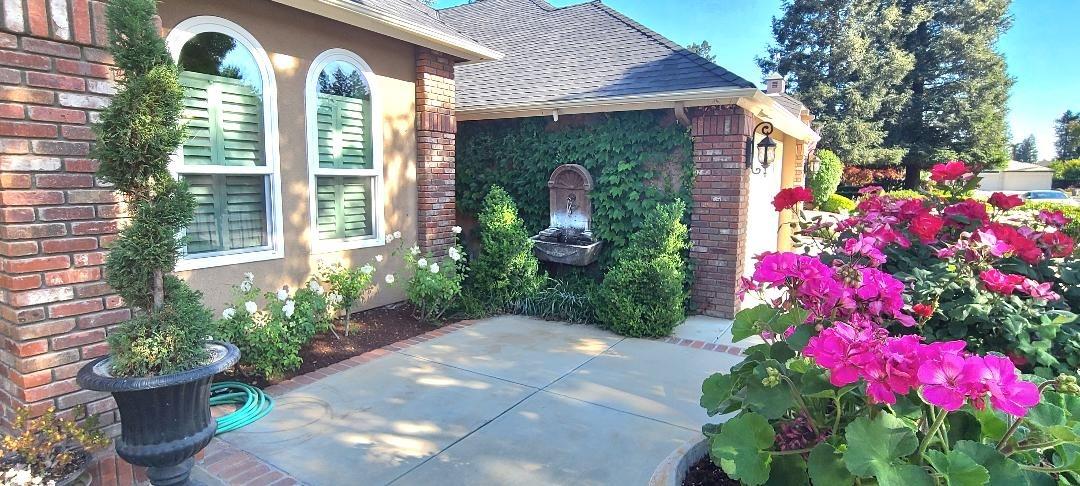 7322 North Geraldine Avenue Fresno, CA 93711 - Photo 2 of 36 a front view of house and yard with beautiful flowers