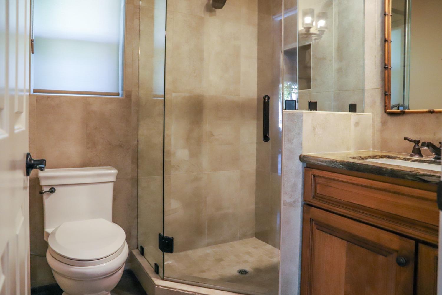 7322 North Geraldine Avenue Fresno, CA 93711 - Photo 29 of 36 a bathroom with a sink a toilet and shower