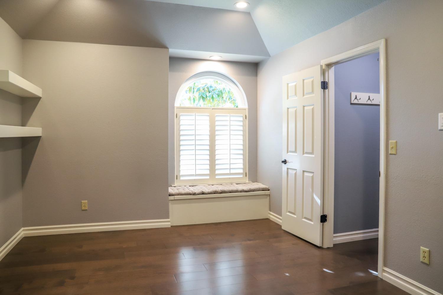 7322 North Geraldine Avenue Fresno, CA 93711 - Photo 30 of 36 an empty room with wooden floor and a window