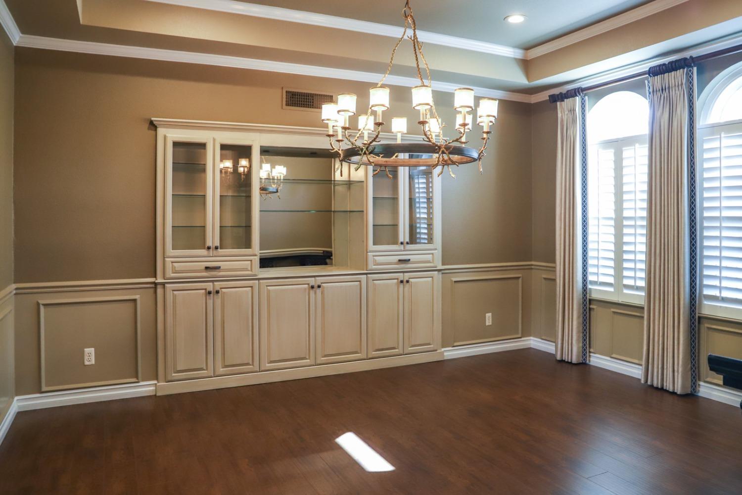 7322 North Geraldine Avenue Fresno, CA 93711 - Photo 7 of 36 a view of a livingroom with a fireplace and chandelier