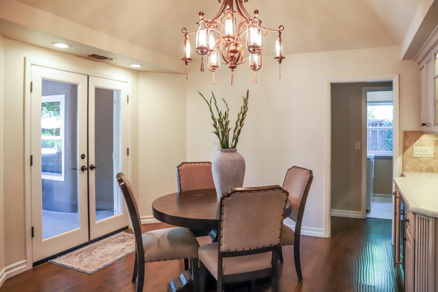 7322 North Geraldine Avenue Fresno, CA 93711 - Photo 8 of 36 a view of a dining room with furniture and wooden floor