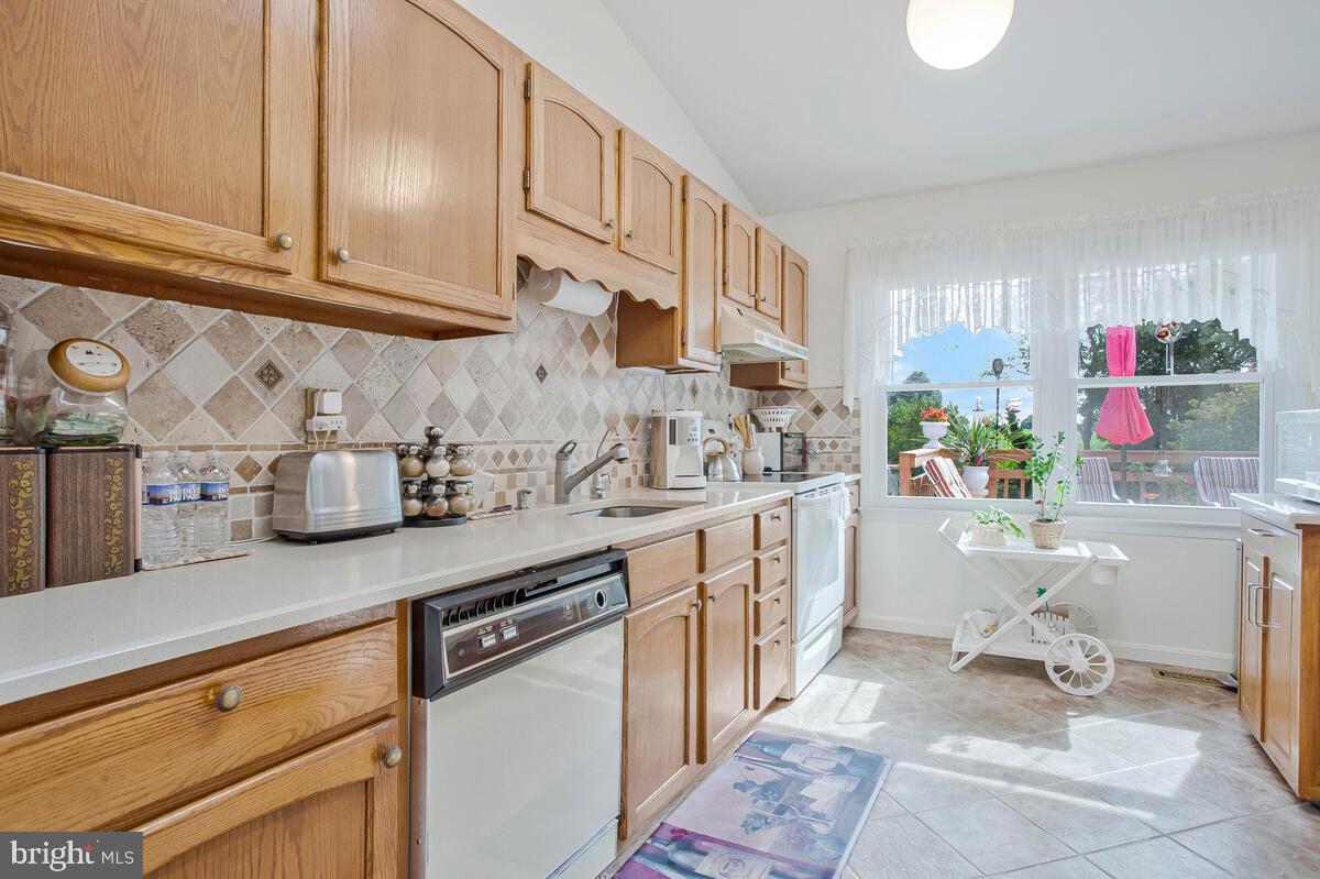674 Teton Drive Lothian, MD 20711 - Photo 11 of 38 a kitchen with granite countertop a sink stainless steel appliances and cabinets