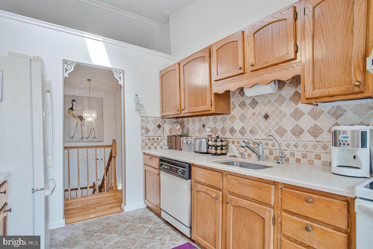 674 Teton Drive Lothian, MD 20711 - Photo 12 of 38 a kitchen with stainless steel appliances granite countertop a sink and cabinets