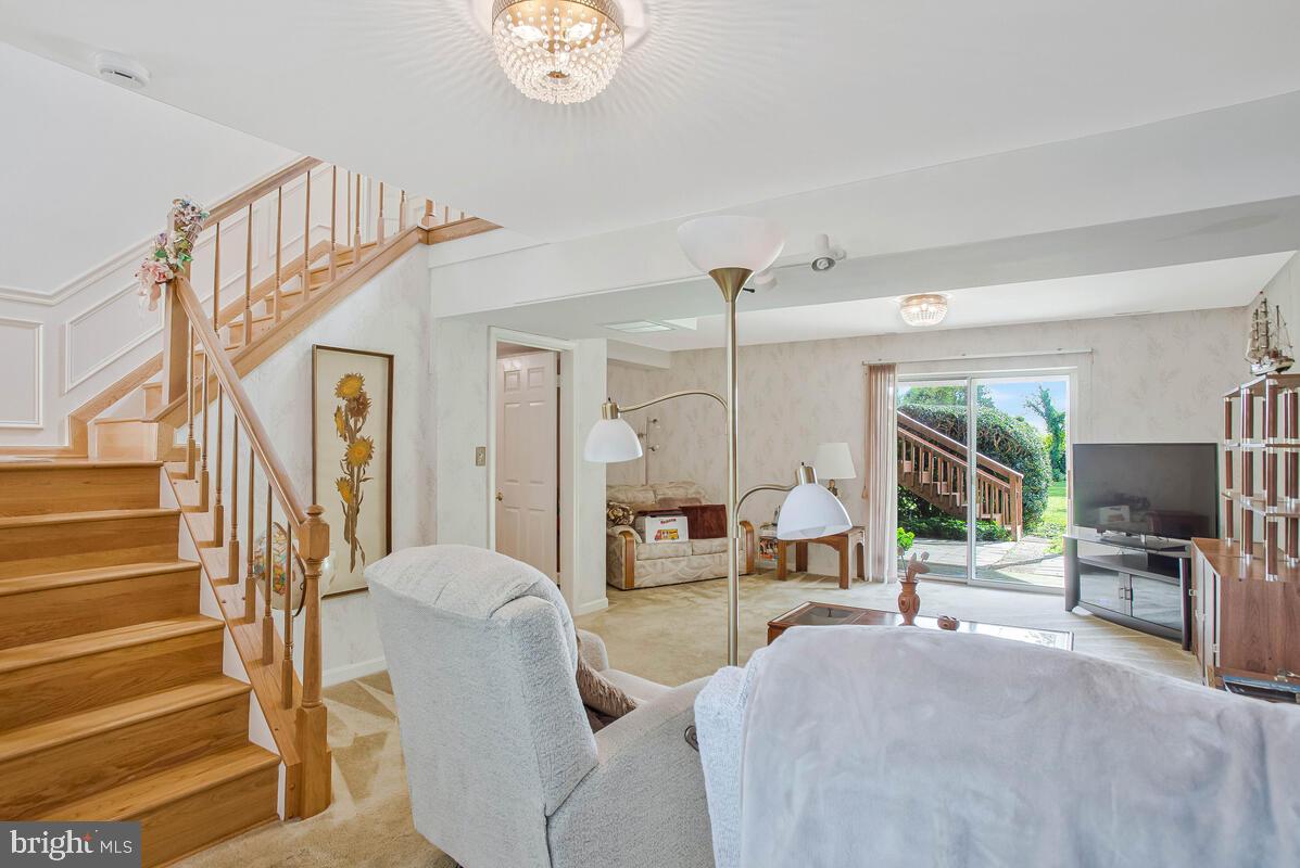 674 Teton Drive Lothian, MD 20711 - Photo 22 of 38 a living room with furniture a large window and a chandelier