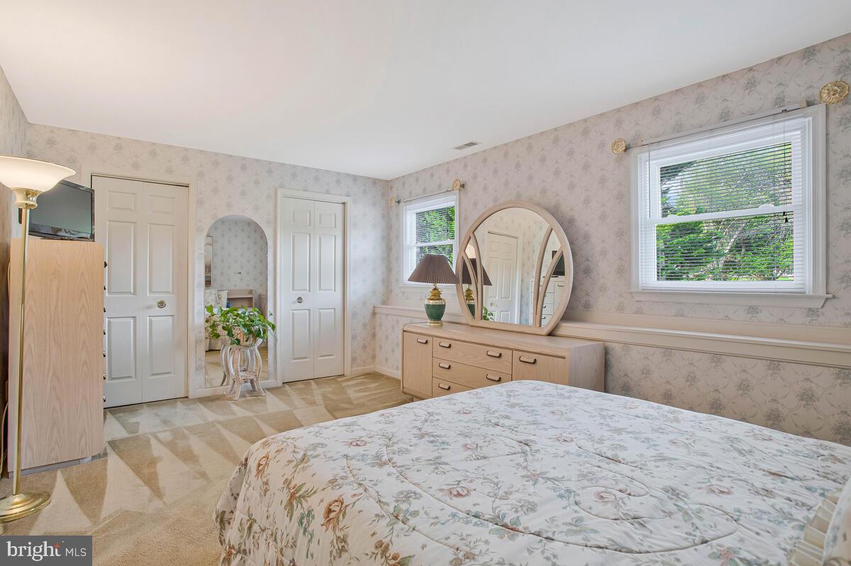 674 Teton Drive Lothian, MD 20711 - Photo 28 of 38 a bedroom with a large bed and wooden floor